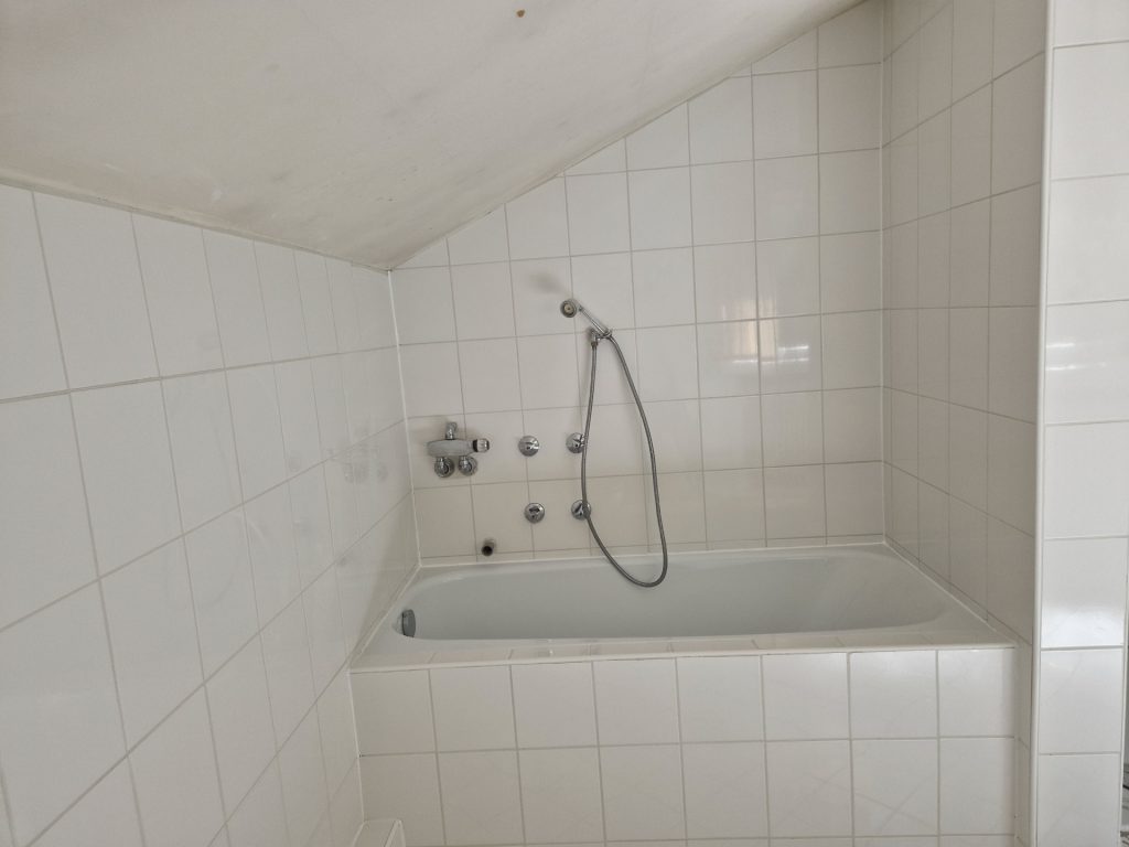 Badezimmer mit Badewanne und Fliesen